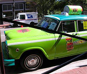 A taxi cab decorated with SURGE paraphernalia.